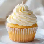 Cupcakes with colorful frosting options and a bowl of sprinkles nearby, ready for decorating with the kids.