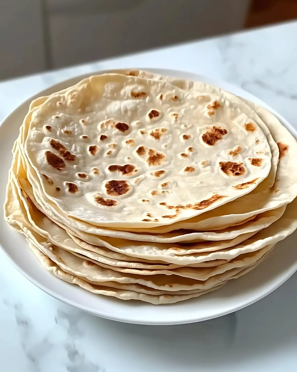 Homemade tortillas with char marks stacked