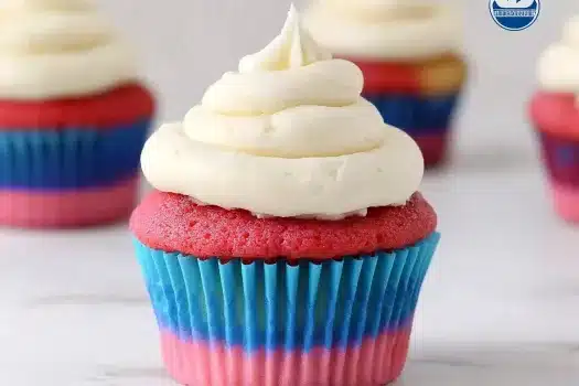 Social media banner for 4th of July cupcakes showing a bite-taken patriotic cupcake with red, white and blue colors