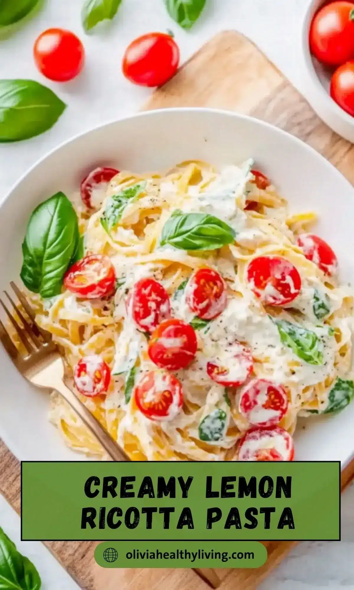 Overhead view of lemon ricotta pasta in white bowl with halved cherry tomatoes and basil, gold fork on side, with green text overlay reading "Creamy Lemon Ricotta Pasta" and website attribution