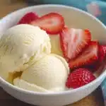 Grilled hamburger patties being brushed with barbecue sauce