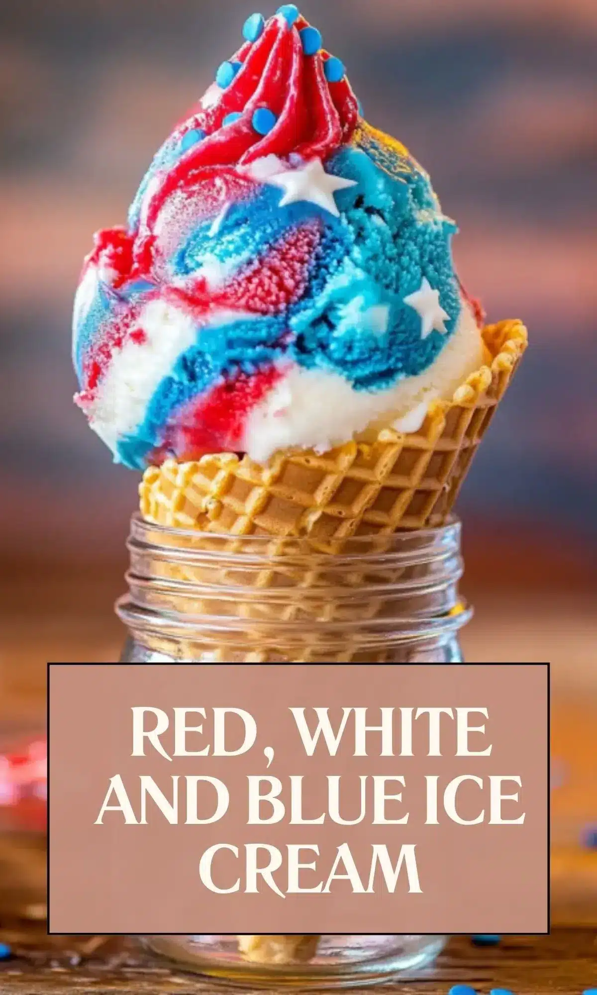 Close-up of red, white and blue swirled soft-serve ice cream in waffle cone with blue candy toppings and star decorations, with text overlay reading 'RED, WHITE AND BLUE ICE CREAM