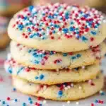 Four stacked sugar cookies with red, white, and blue sprinkles both on top and baked inside for a festive Fourth of July dessert