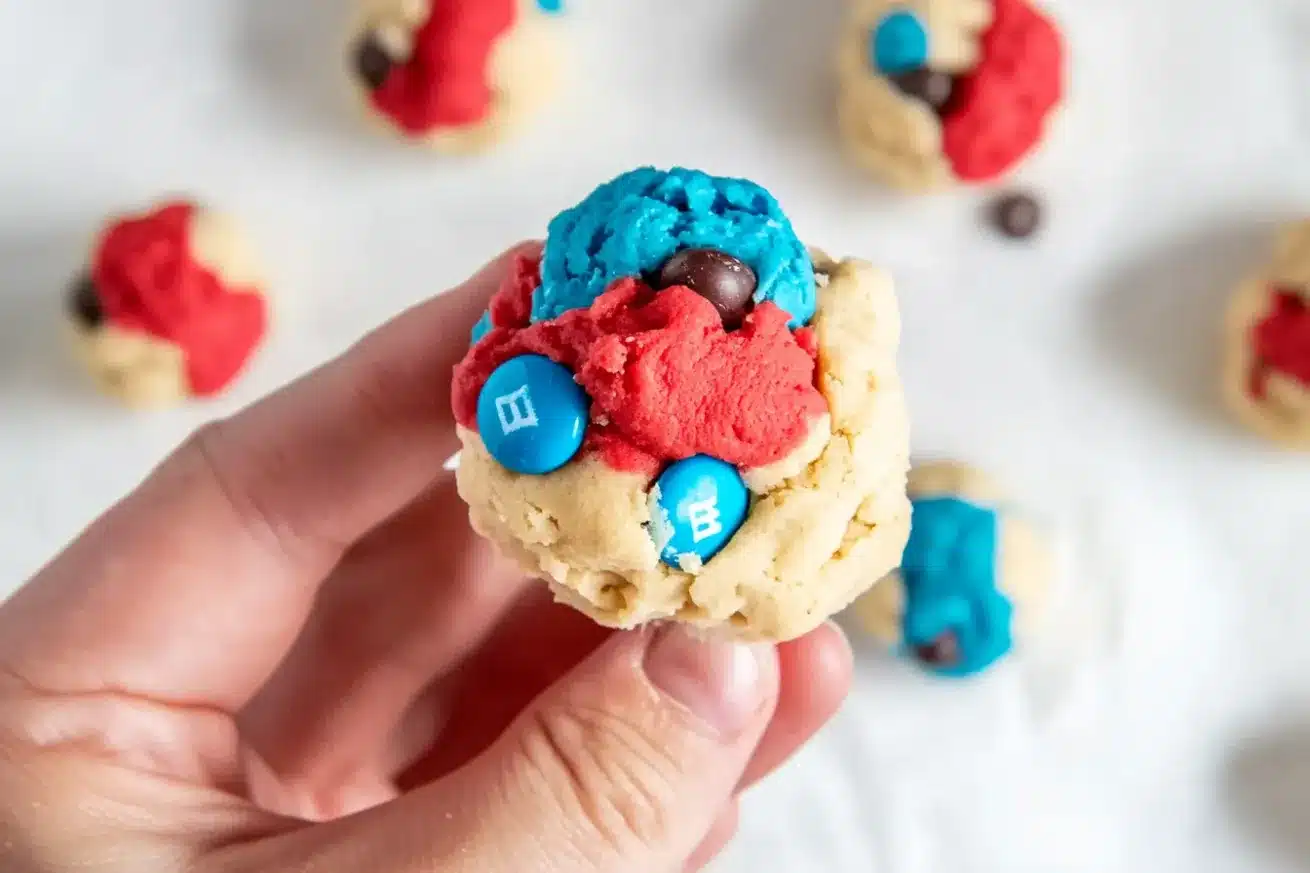 Close-up of two patriotic cookies showing the distinct red, white and blue colored dough with M&Ms on top