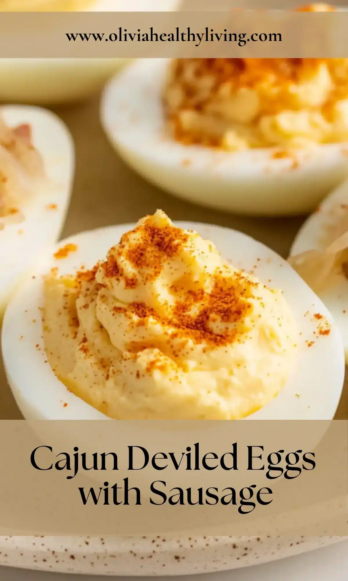 Close-up of a single Cajun deviled egg with creamy yellow filling, seared andouille sausage slice, and red paprika garnish on a speckled ceramic plate