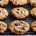 Close-up of golden brown cherry chocolate chip cookies on cooling rack displaying chewy texture and sea salt topping