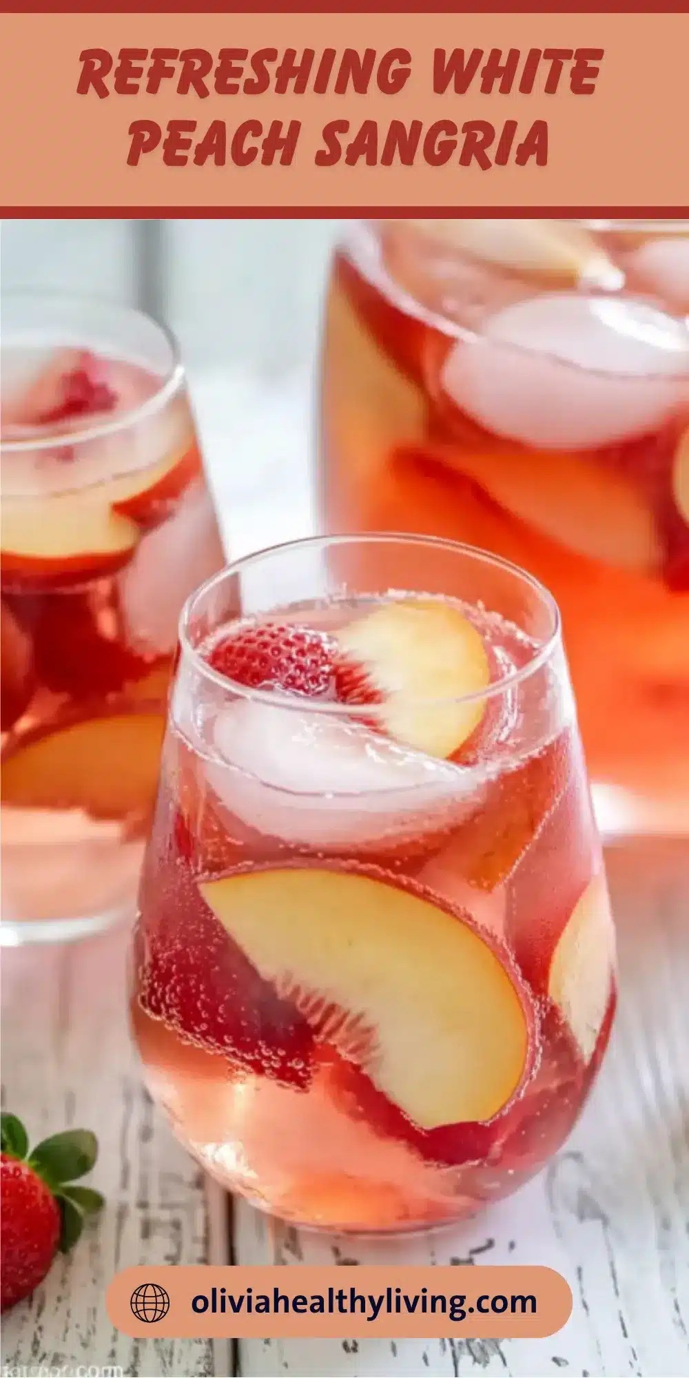 Glass of refreshing white peach sangria with fresh peach slices and strawberries, served over ice on wooden surface