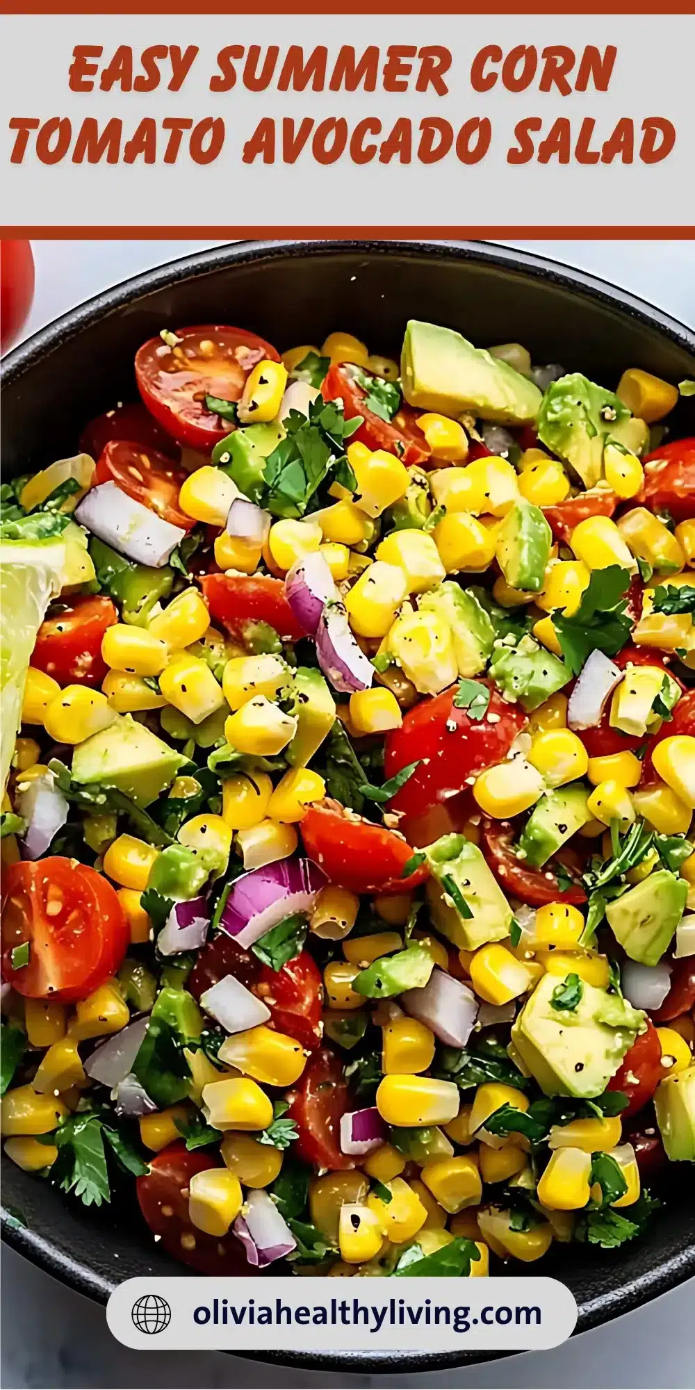 Fresh corn tomato avocado salad with cilantro and red onion in a dark bowl, topped with lime dressing and black pepper