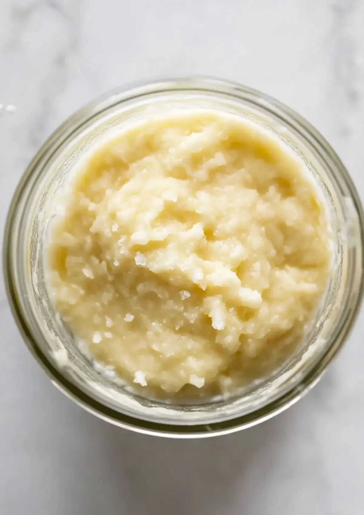 Blended garlic, lemon, and salt paste in glass jar before adding oil