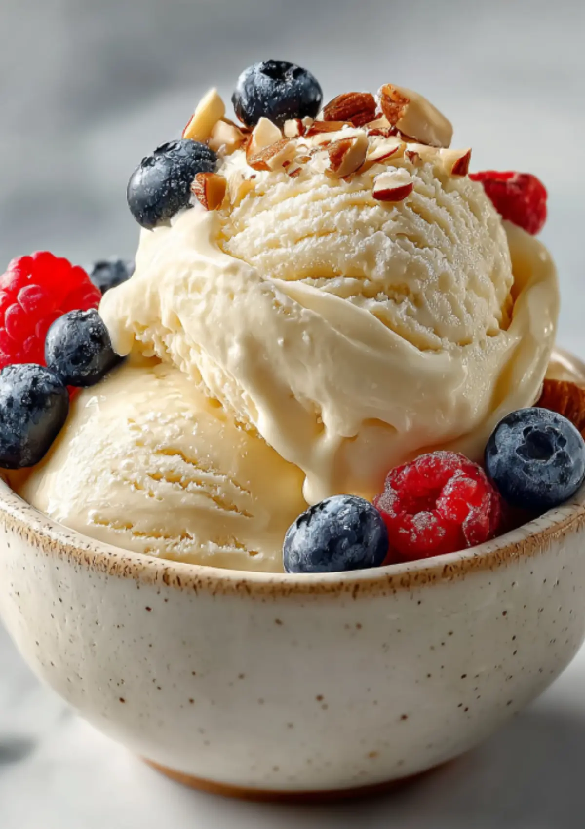 Scoops of vanilla ice cream topped with fresh blueberries