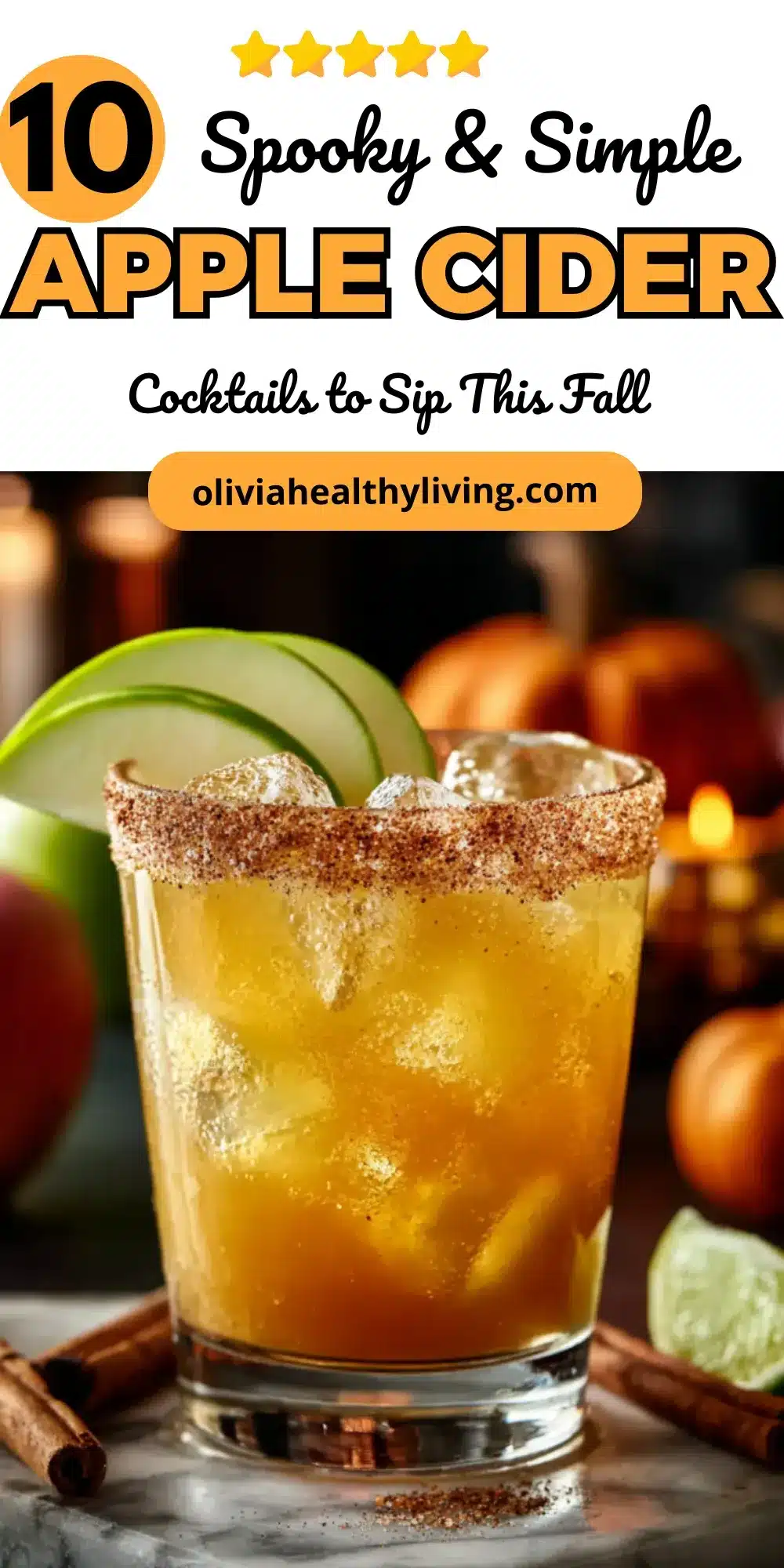 Apple cider cocktail in a rimmed glass with cinnamon sugar, garnished with green apple slices and surrounded by autumn décor.