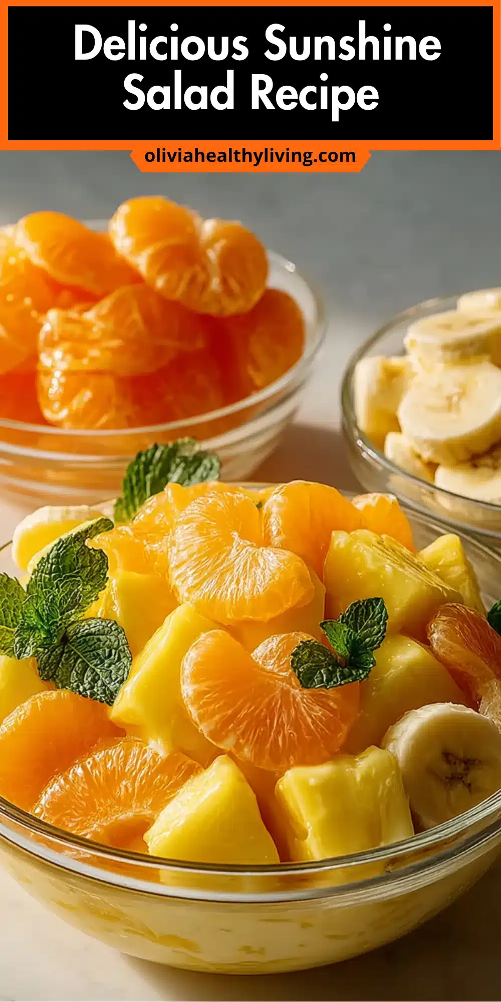 Colorful fruit salad with pineapple, oranges, and bananas garnished with mint leaves in a glass bowl