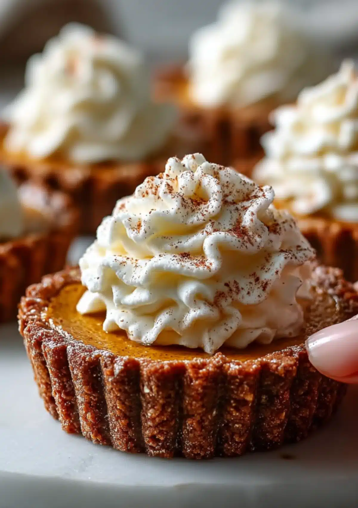 Close-up of a pumpkin protein pie being held