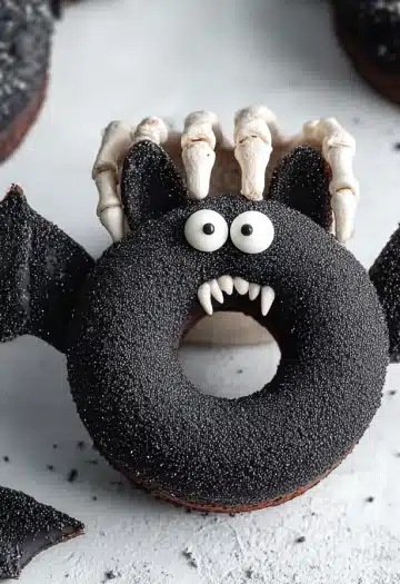 Halloween bat donut with skeleton hand, white candy fangs