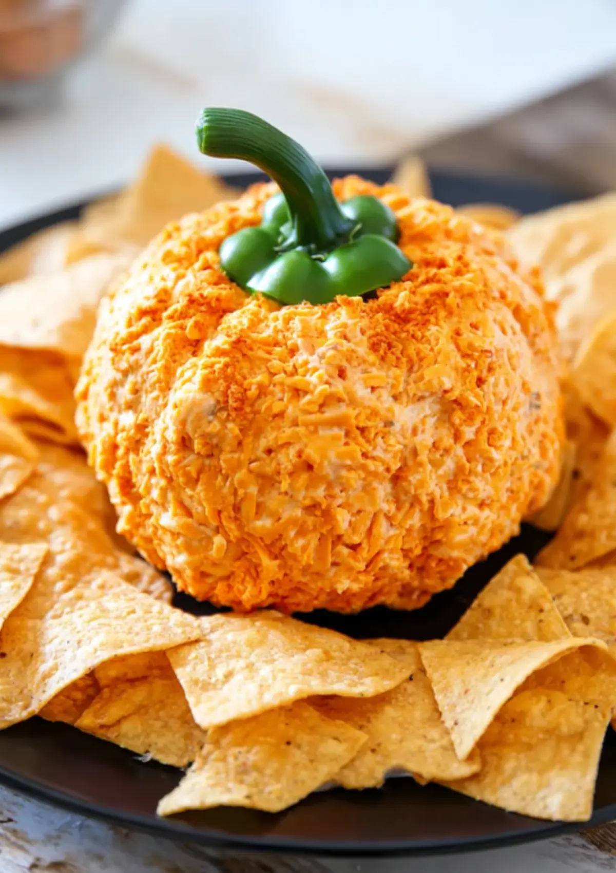 Pumpkin-shaped cheese ball with tortilla chips
