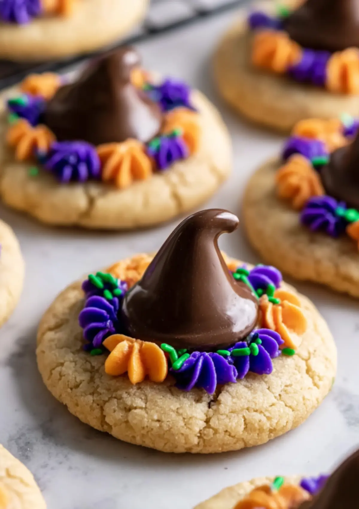 Witch hat cookies with chocolate kiss and purple and orange frosting