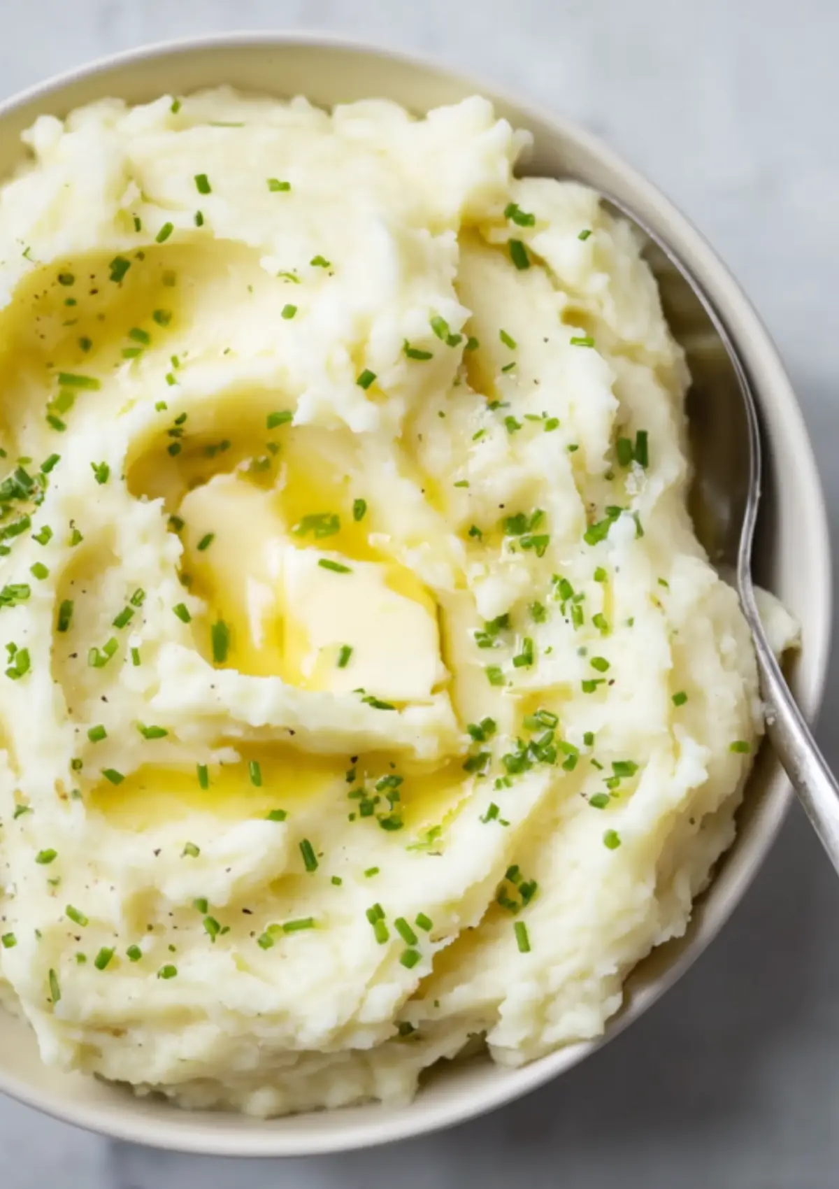 Bowl of homemade garlic mashed potatoes with olive oil drizzle
