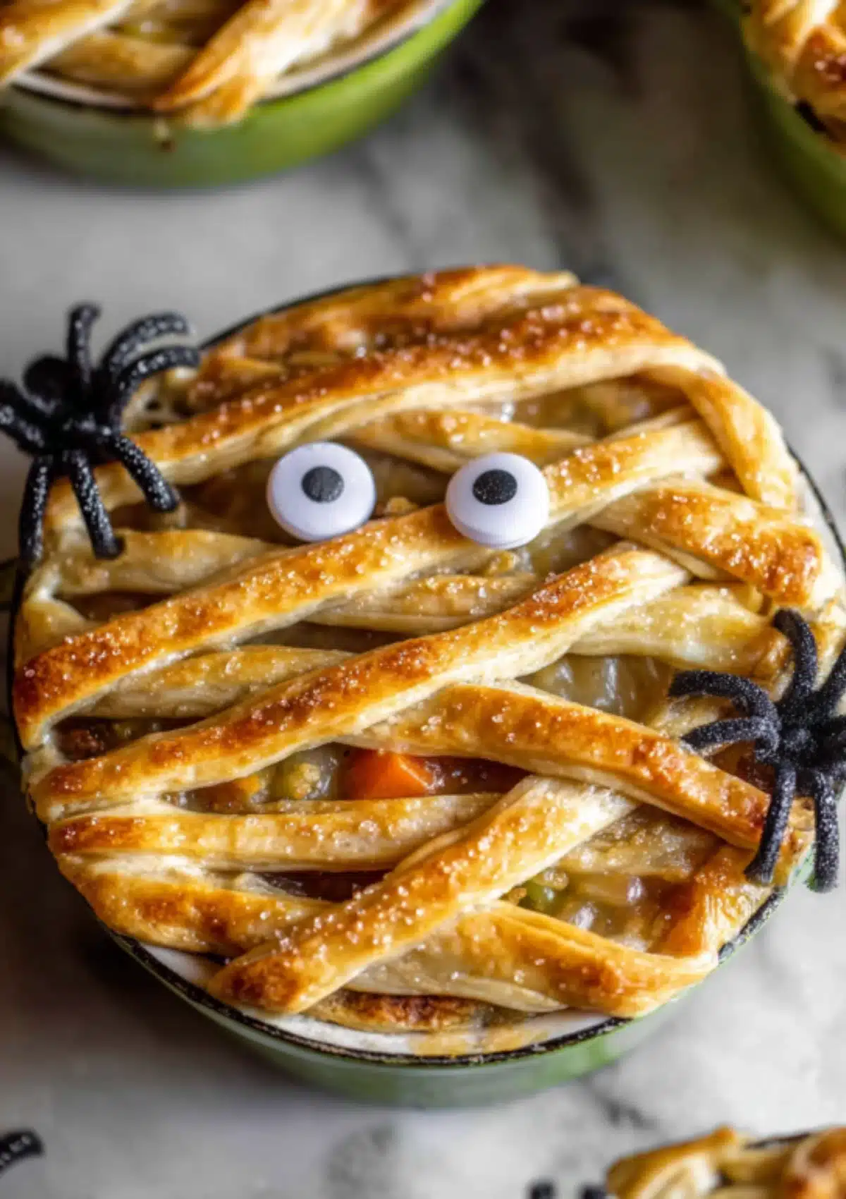 Chicken pot pie with golden lattice crust and mummy face design