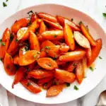 Honey glazed carrots served on white plate