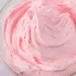 Pink buttercream in mixing bowl