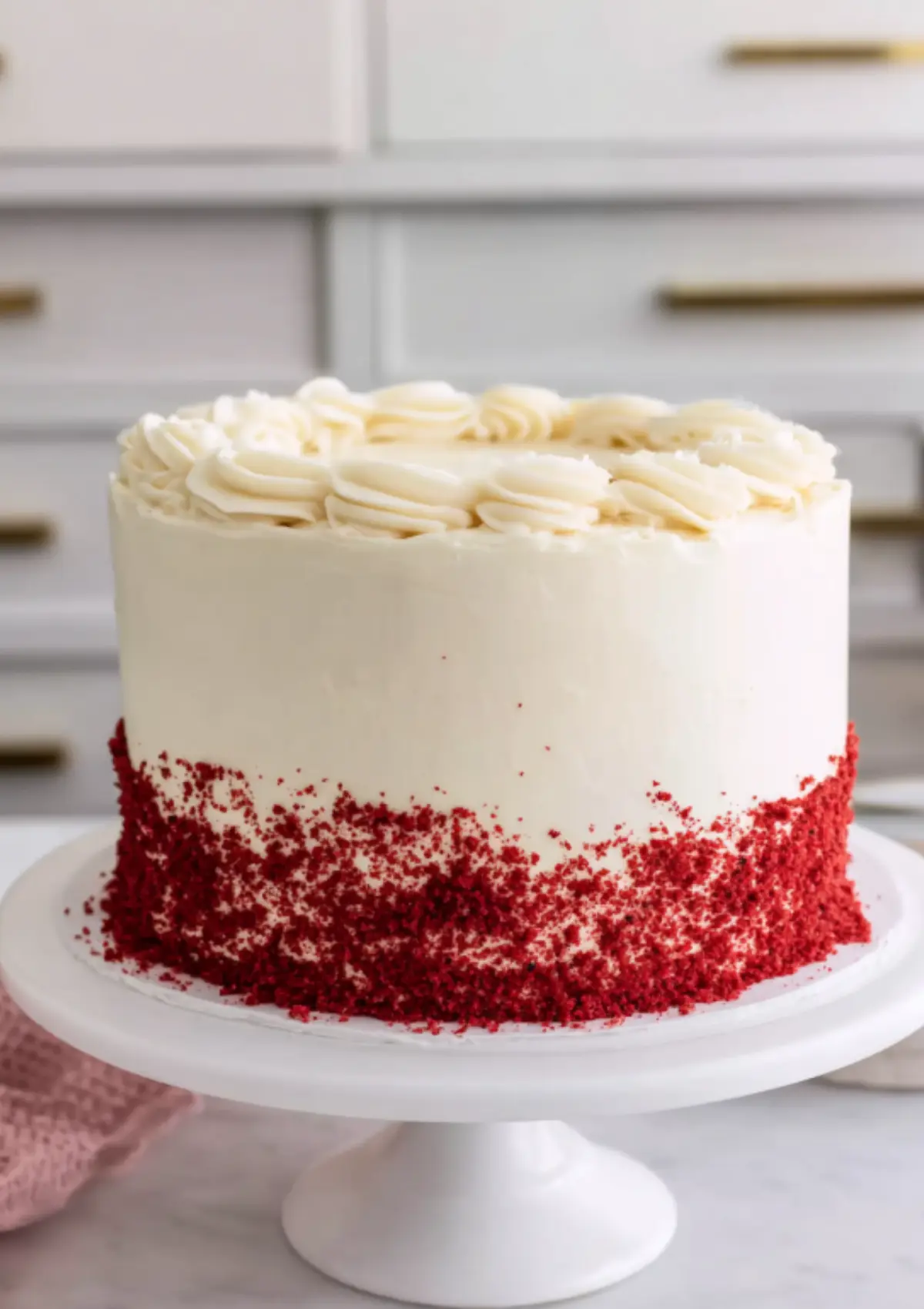 Red velvet cake with cream cheese frosting and red crumb coating