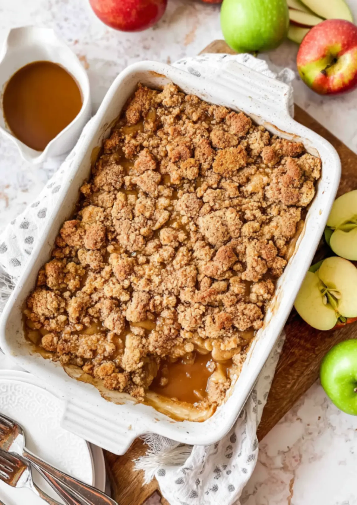 Apple crumble in white baking dish overhead view