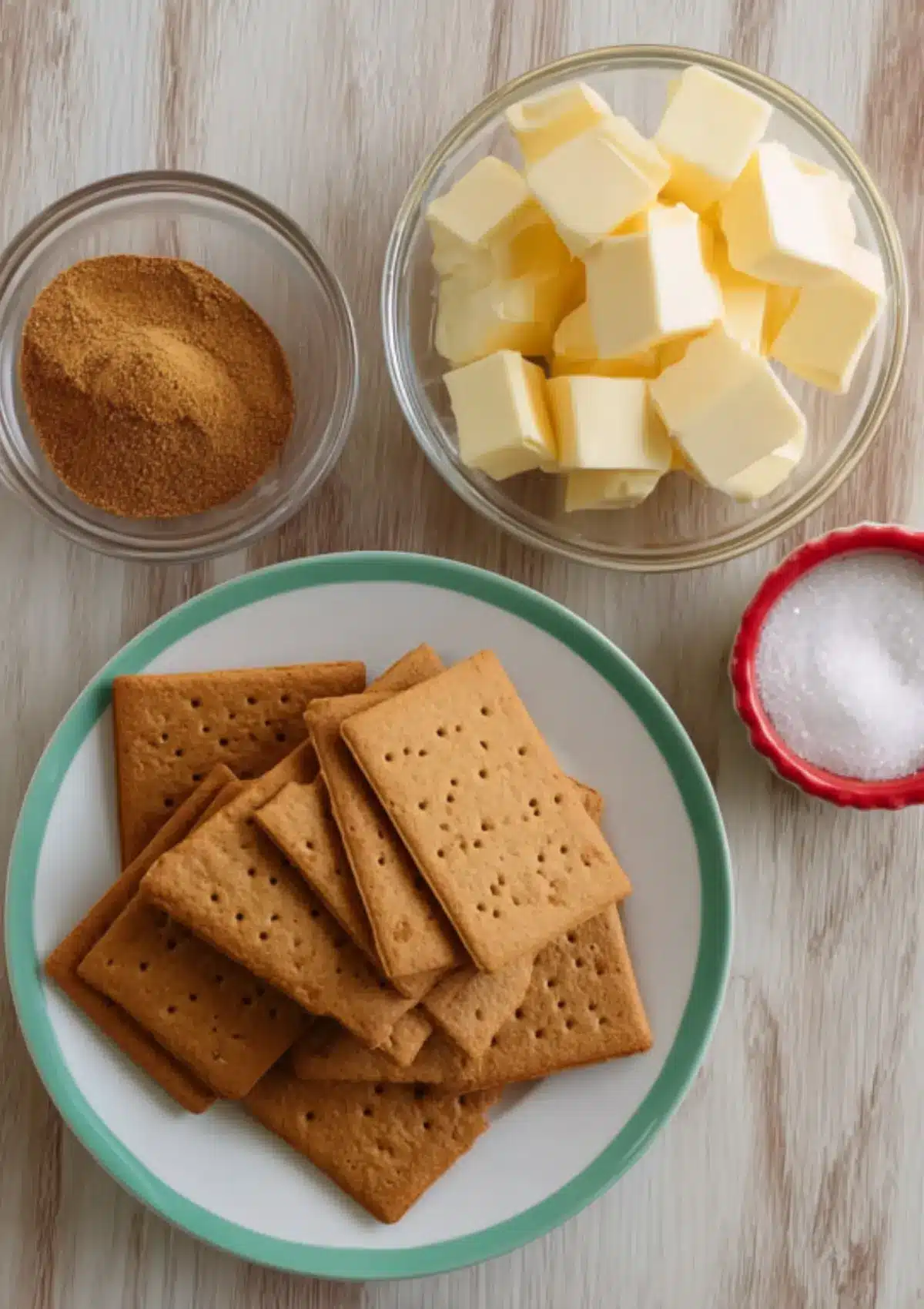 Graham crackers, butter, and spices in bowls