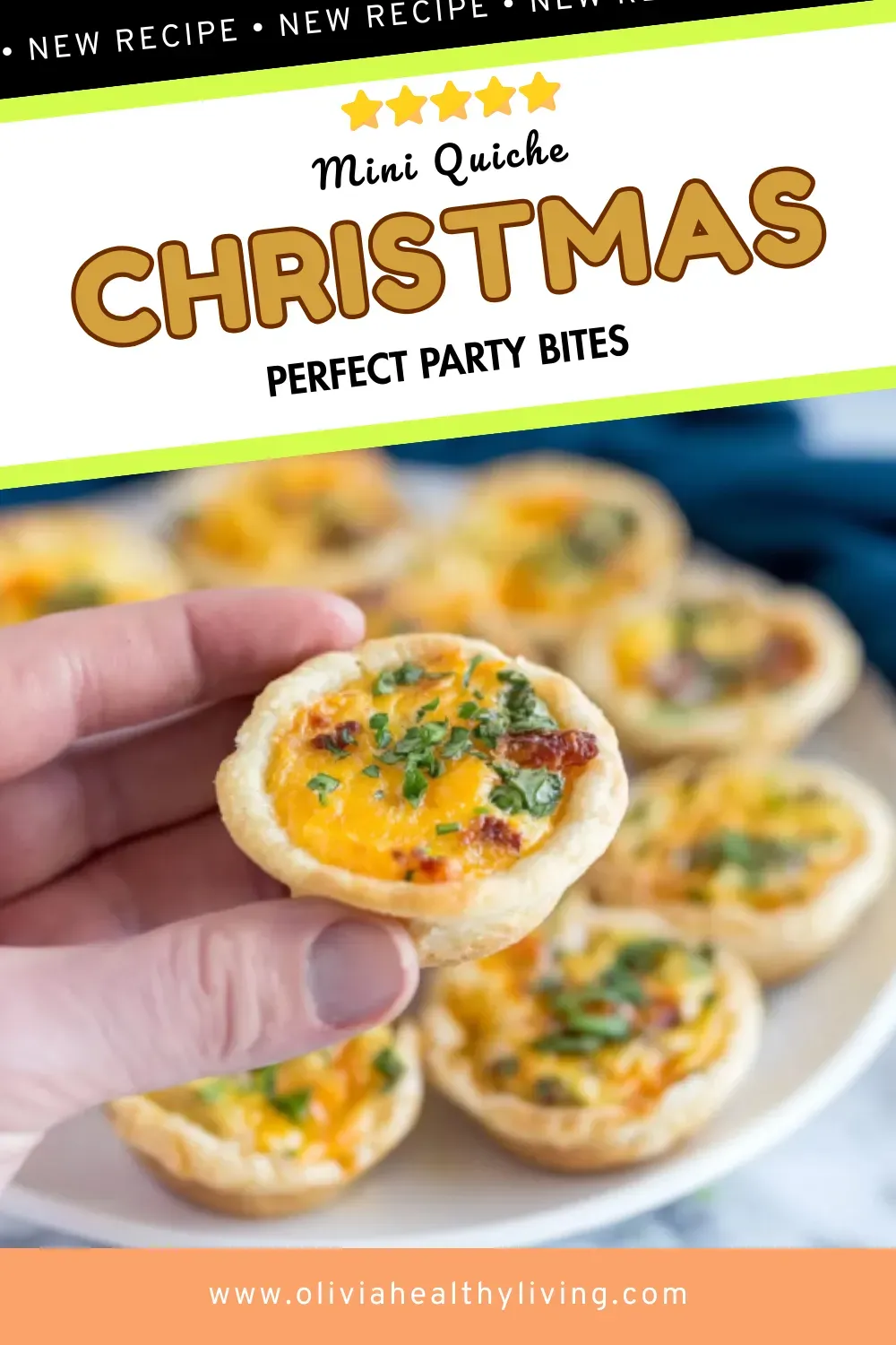 Hand holding mini quiche with golden crust, melted cheddar cheese, bacon bits and fresh chives with more quiches blurred in background